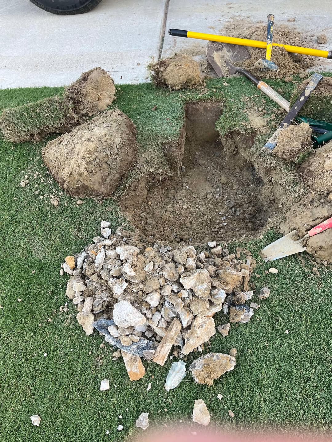 Buried construction debris under lawn soil Sudbury Ontario excavation