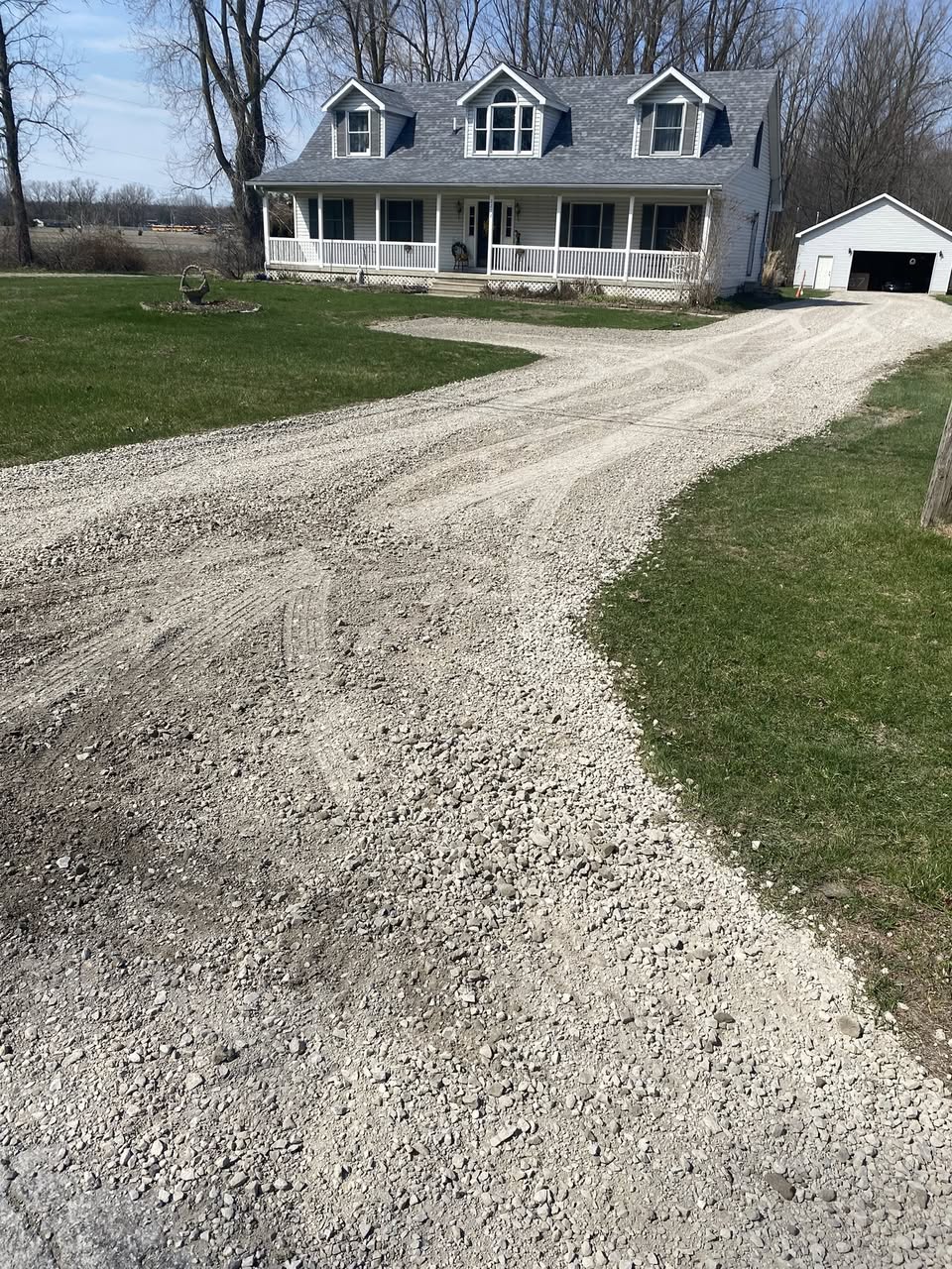 Clean gravel driveway alongside a well maintained lawn in Greater Sudbury