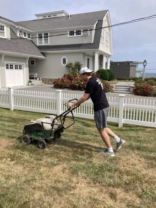 Core aeration machine pulling soil plugs from compacted lawn