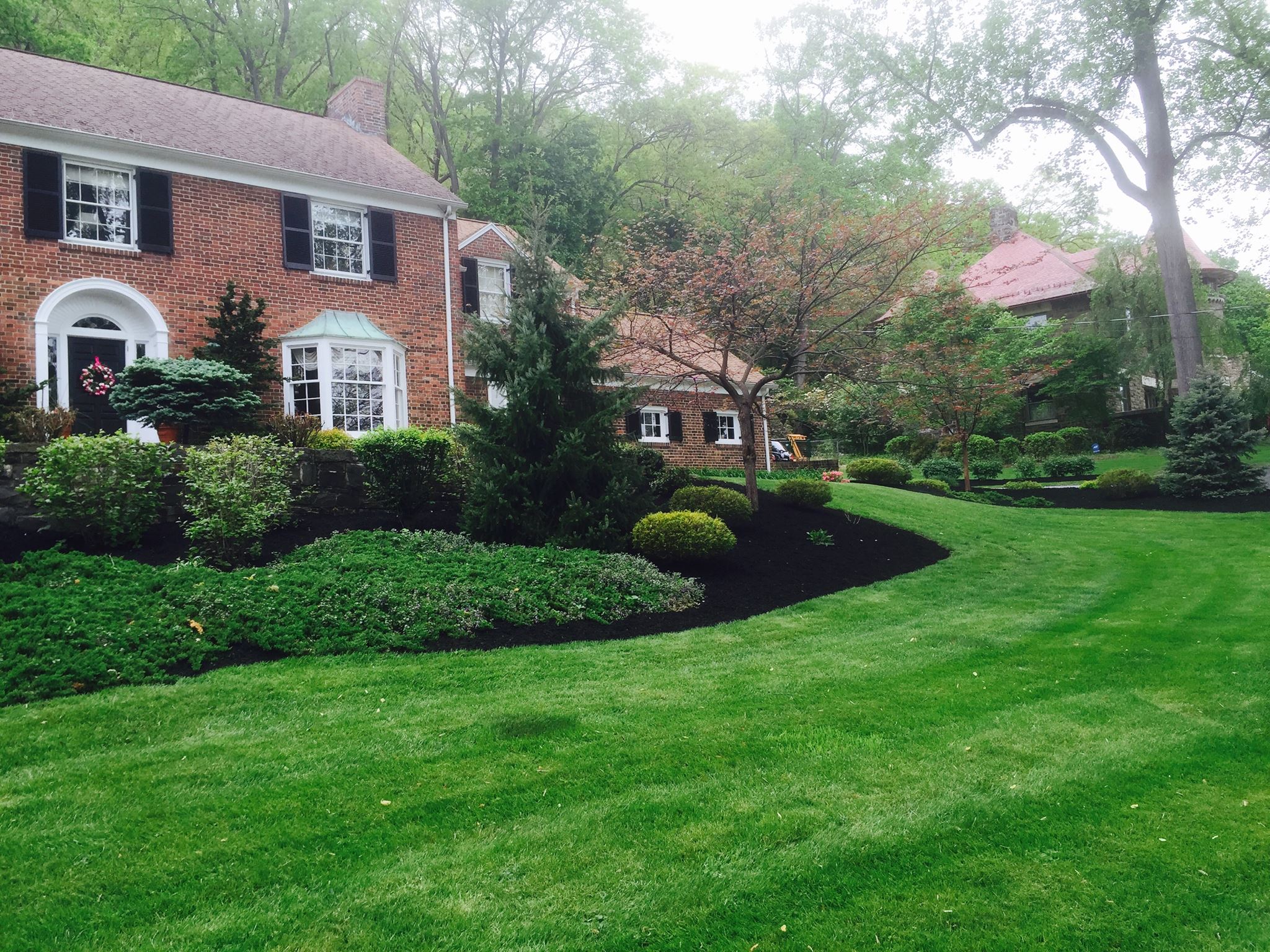 Cutting Edge Lawn crew working Sudbury property spring