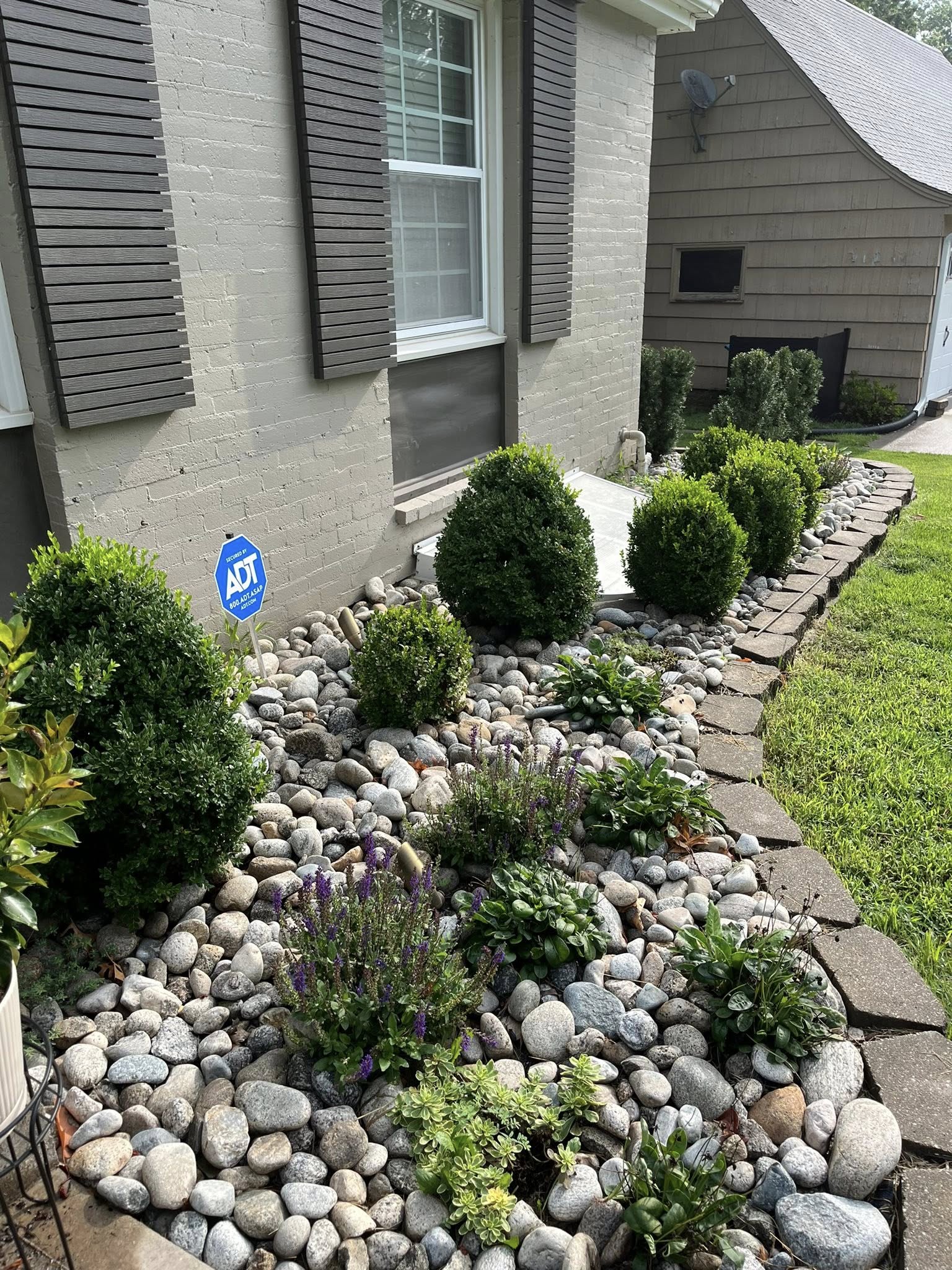 Decorative stone and mulch installation in a Sudbury residential garden bed