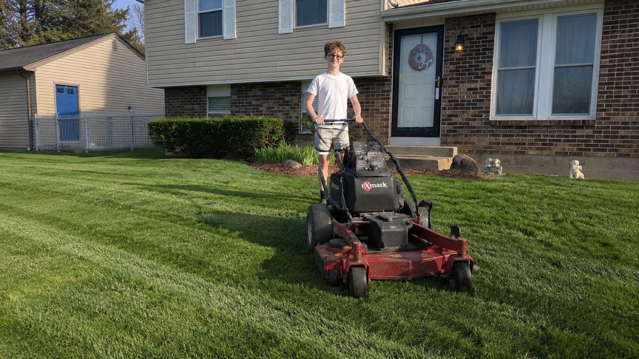 Healthy green residential lawn in Greater Sudbury after simple mower adjustment