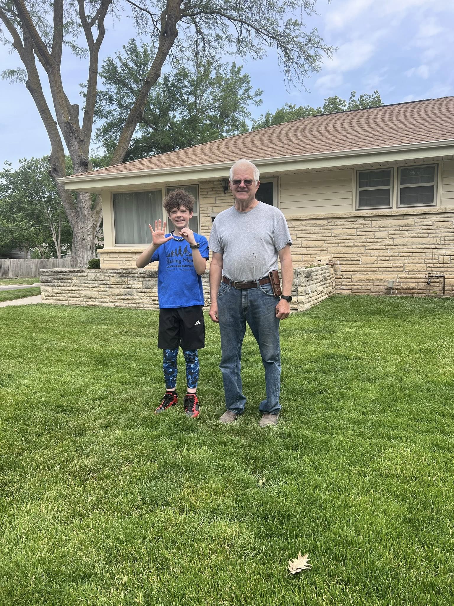 Homeowner inspecting lawn condition in a Sudbury backyard