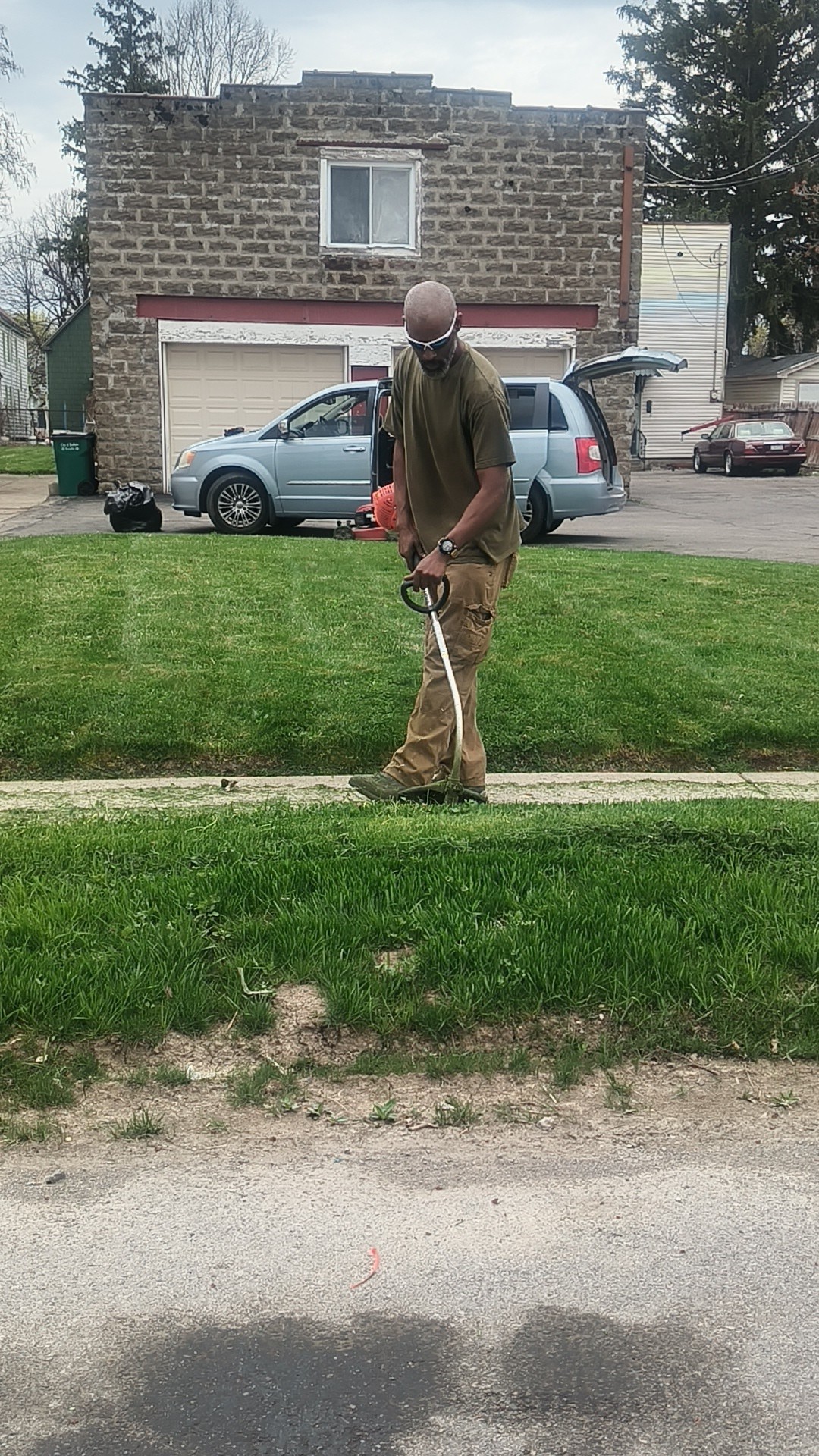 Homeowner reviewing lawn sprinkler system maintenance checklist in Sudbury Ontario backyard