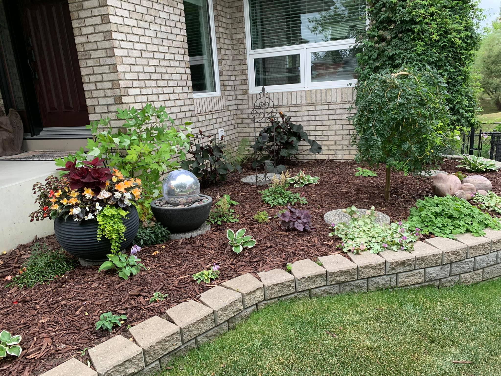 Landscaped shaded garden bed with ground cover plants in a Sudbury Ontario residential yard