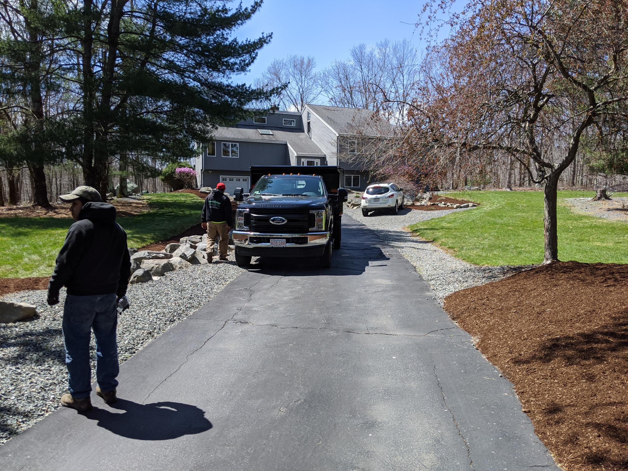 Lawn care professional communicating with a Sudbury customer