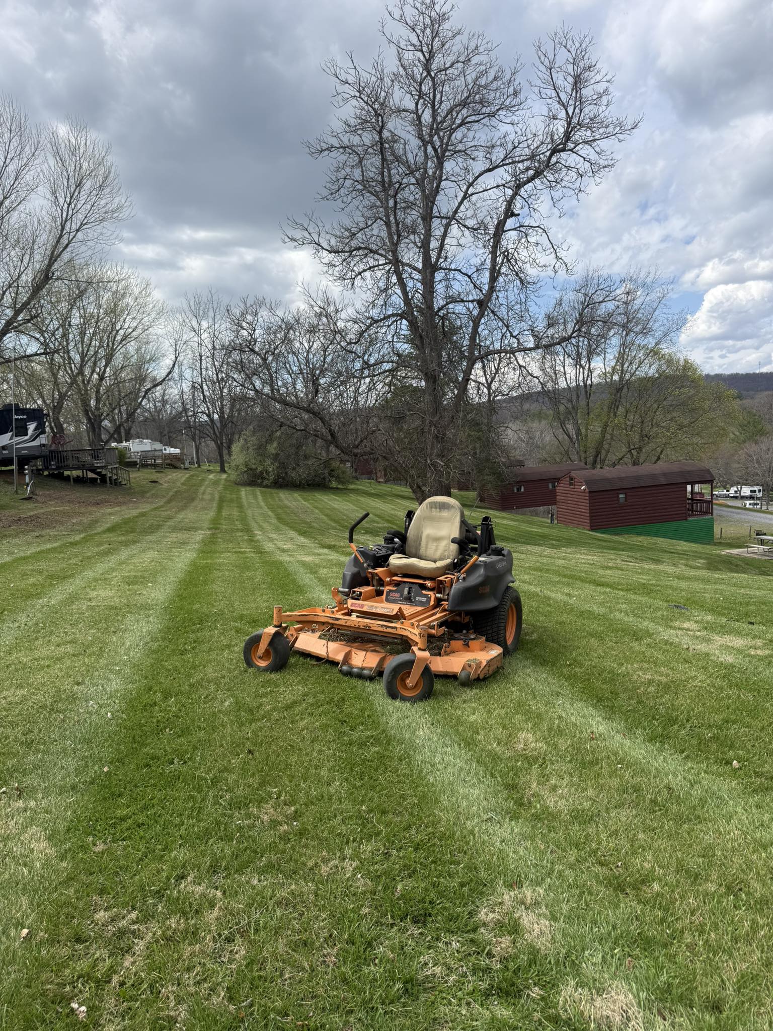 Lawn mower cutting grass to proper height in fall in Sudbury Ontario