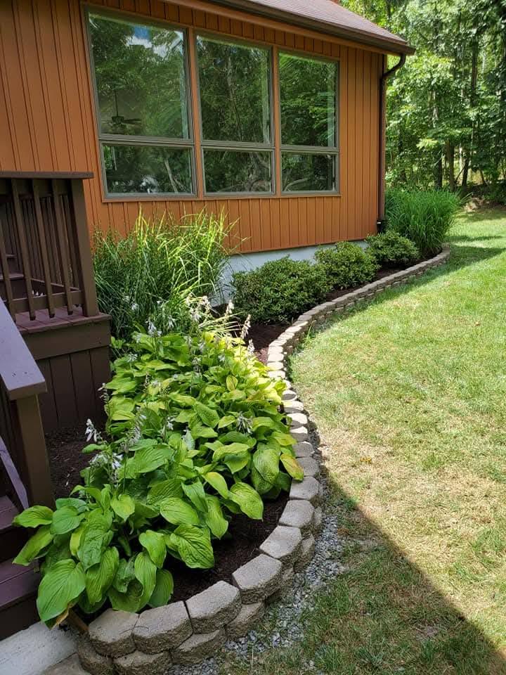 Mulch and stone landscaping comparison on a Sudbury property