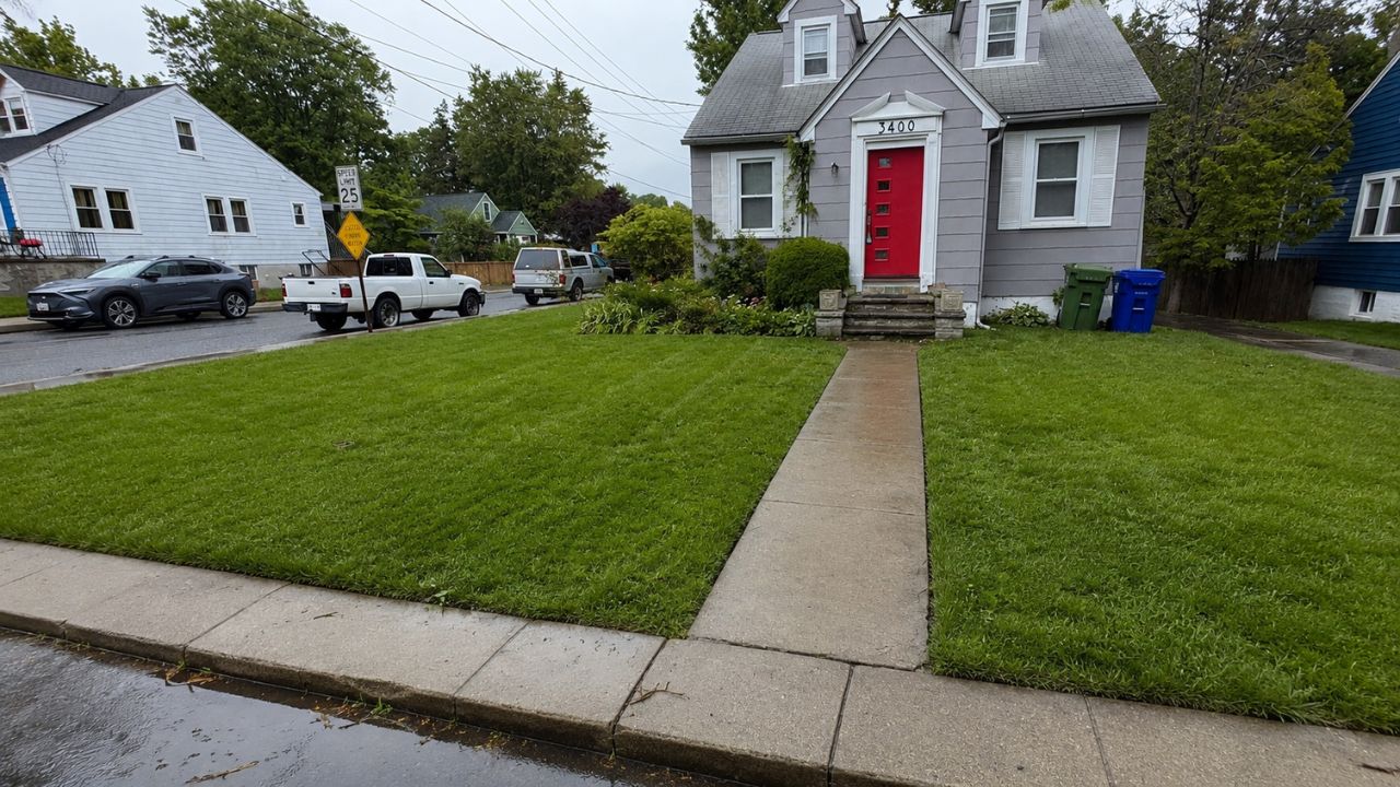 Ryan Lingenfelter talking with a homeowner about their lawn in Greater Sudbury Ontario