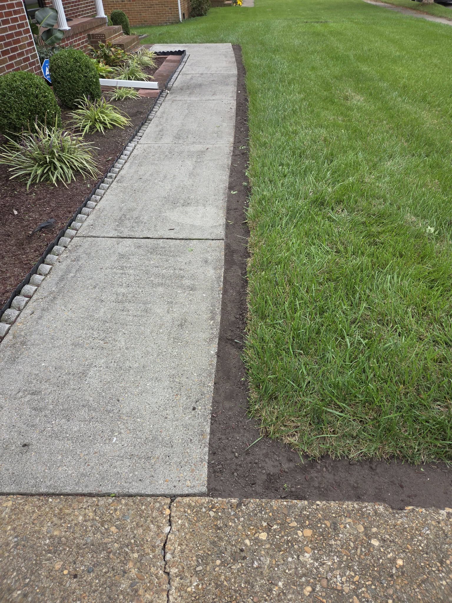 Advanced lawn edge deterioration on a Sudbury Ontario residential property requiring significant repair