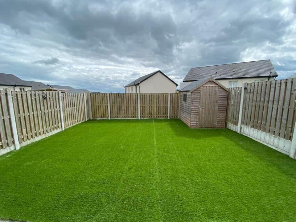 Artificial turf installed in backyard showing heat and wear over time