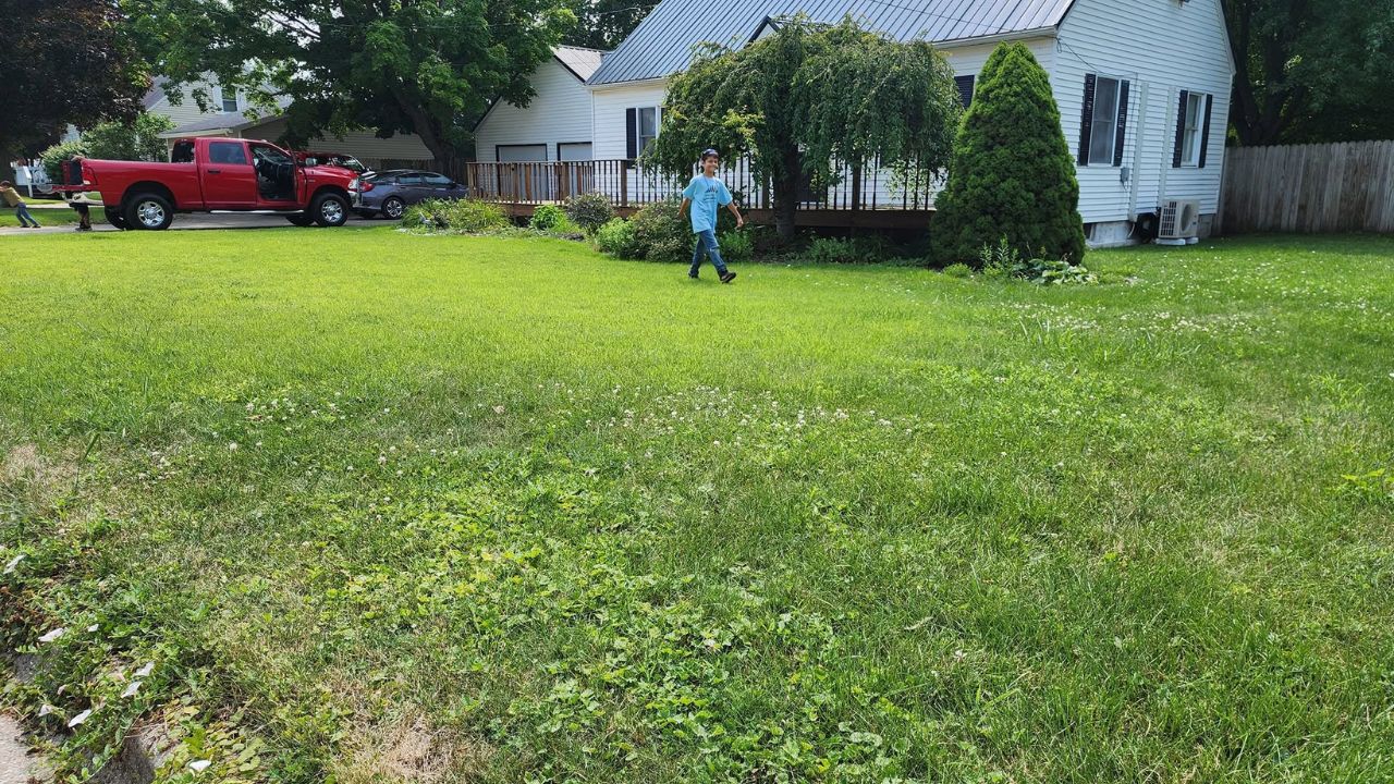 Busy parent managing a residential lawn in Sudbury Ontario