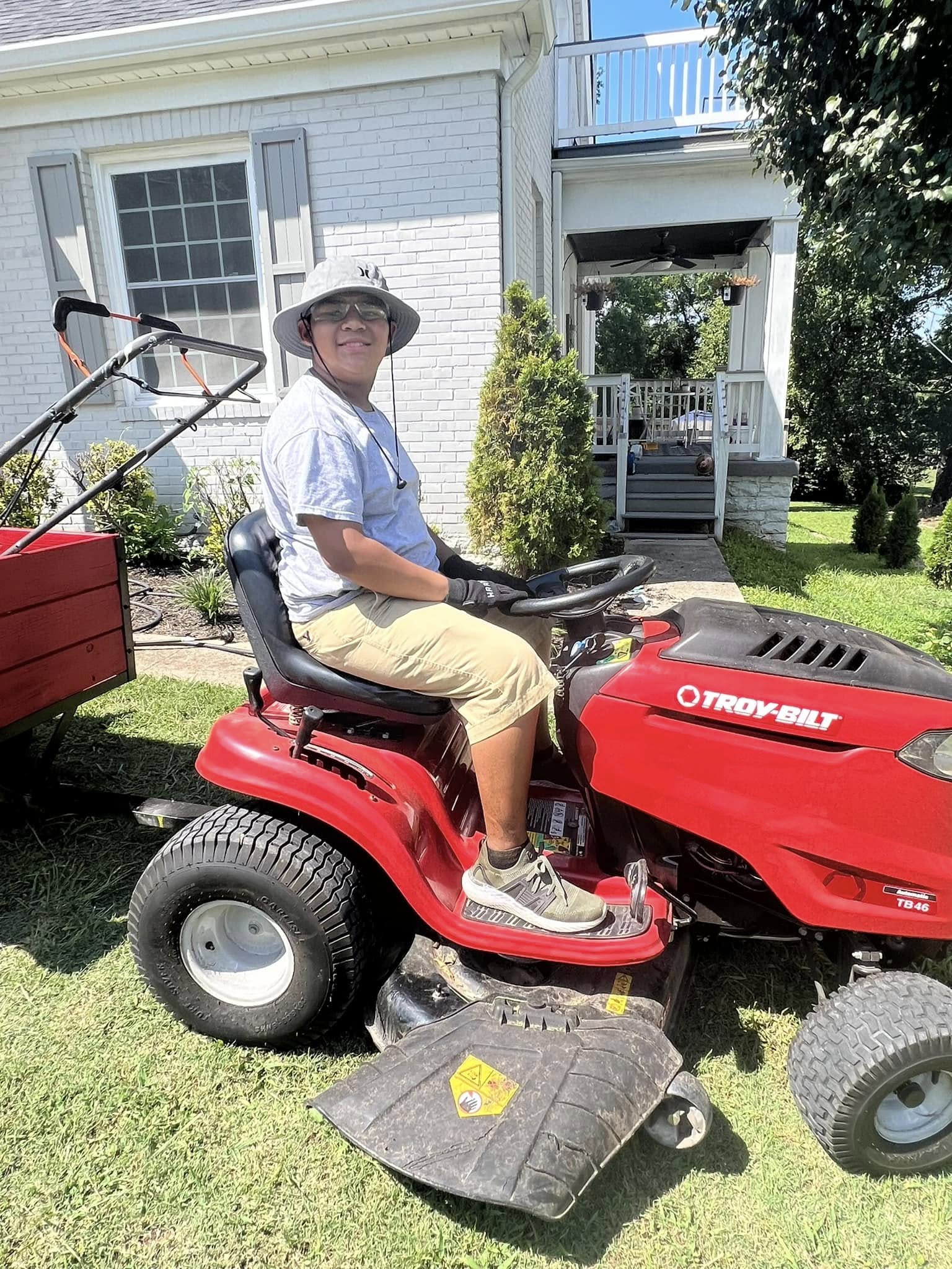 Busy parent managing a residential lawn in Sudbury Ontario