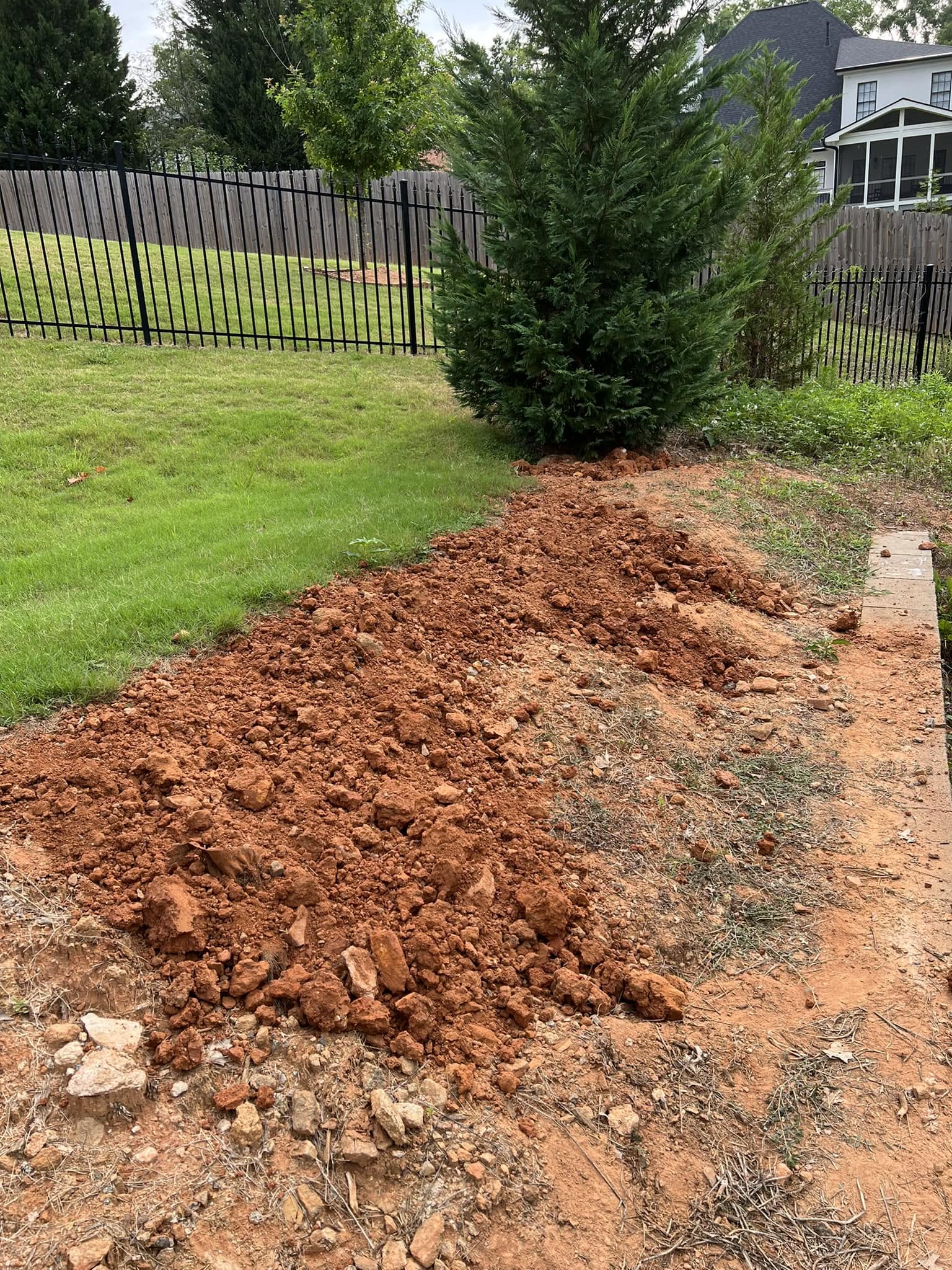Clay soil causing poor drainage in Sudbury Ontario backyard lawn