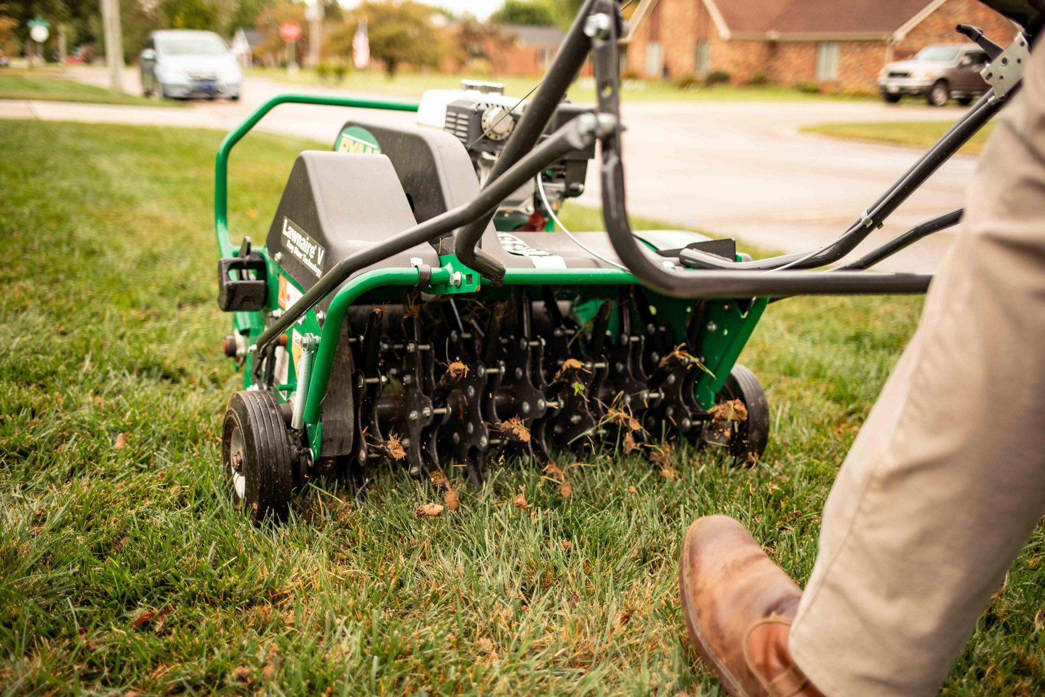 Core aeration being done on a Garson Ontario residential lawn in spring