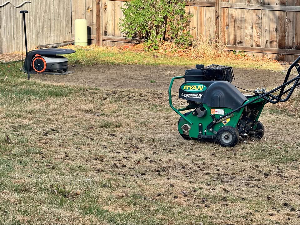 Core aeration machine pulling plugs from a Sudbury lawn