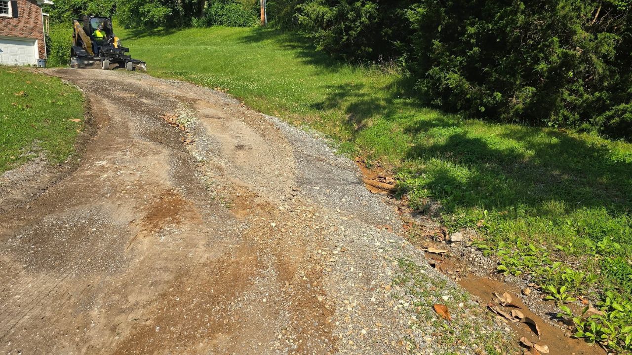 Damaged gravel driveway with deep potholes on a Sudbury Ontario residential property