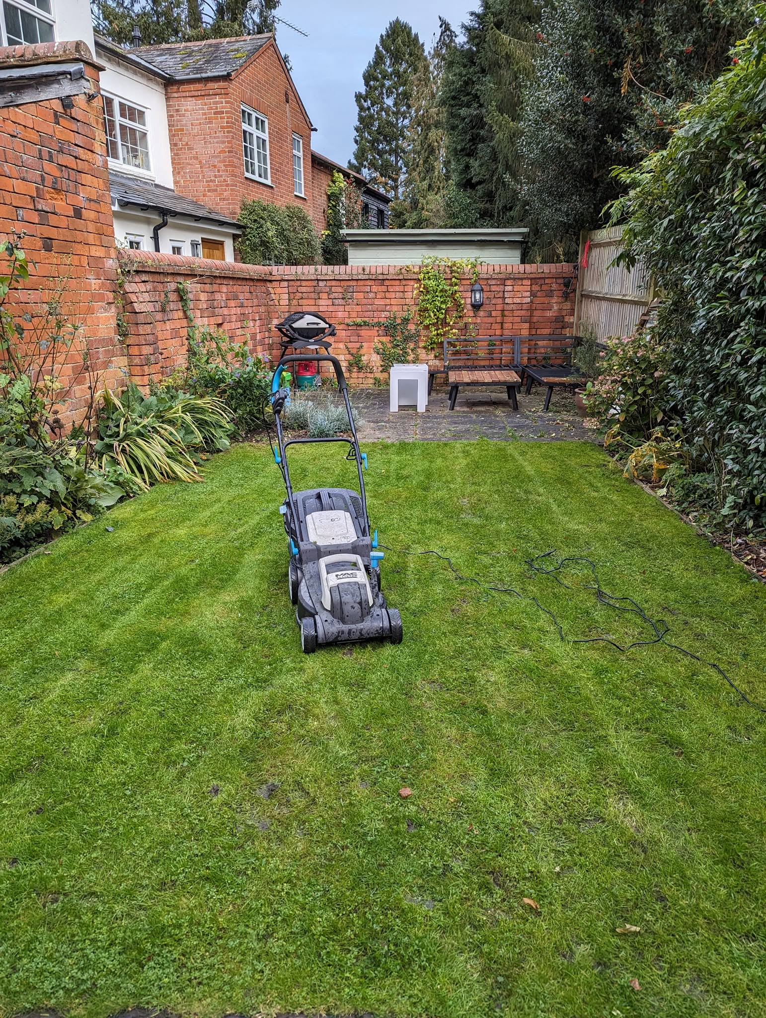 Experienced homeowner walking lawn care professional through her well observed Sudbury Ontario property