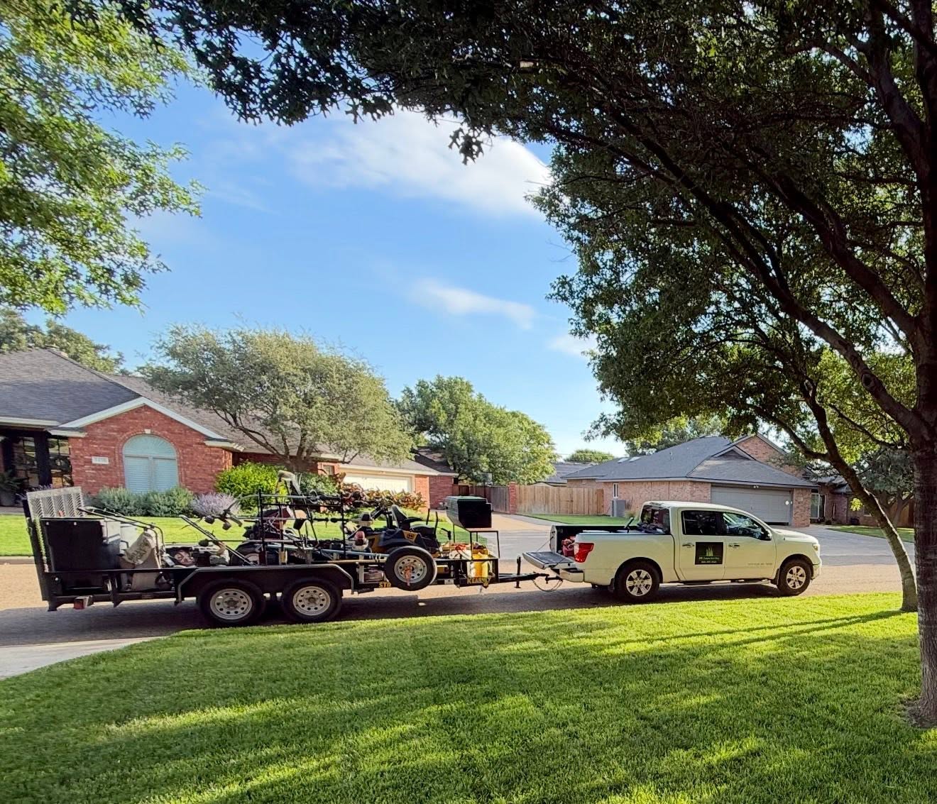 Generic lawn care company truck leaving Sudbury residential property