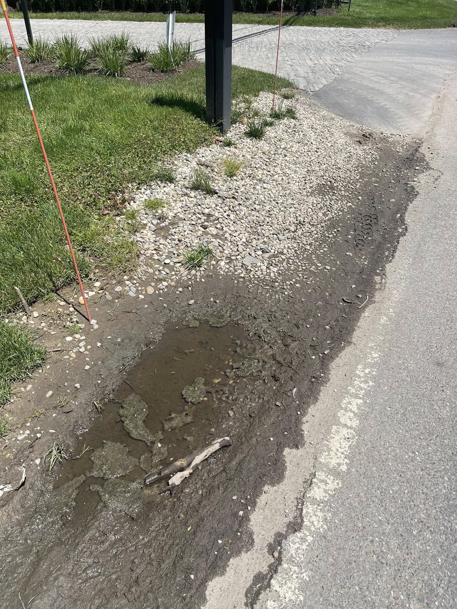 Gravel driveway with poor drainage and standing water on a Sudbury Ontario residential property