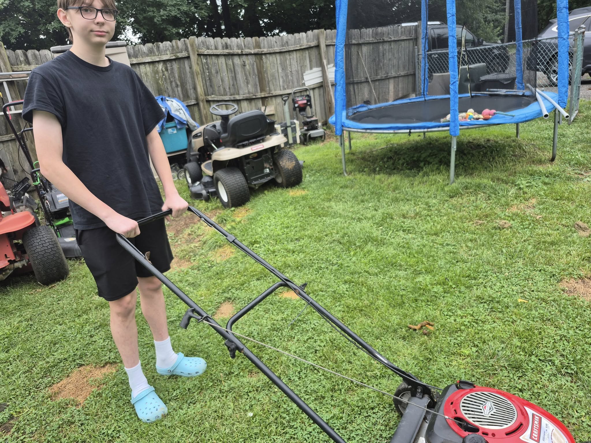 Homeowner on phone asking lawn mowing company questions in Sudbury