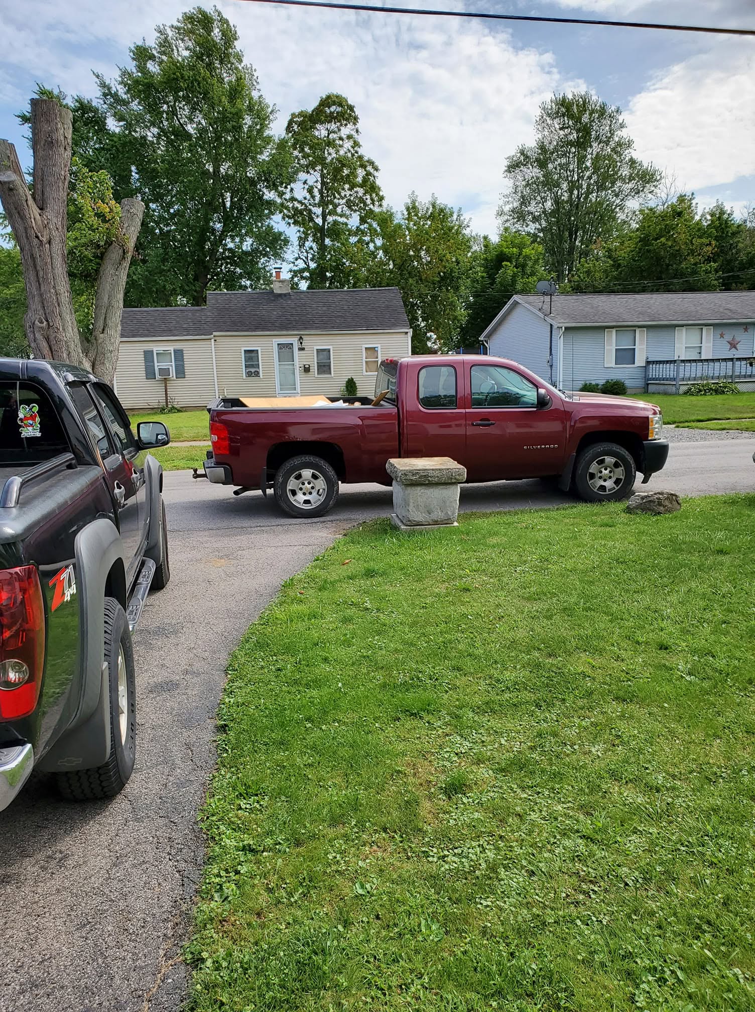 Lawn care owner observing a Sudbury property from his parked truck