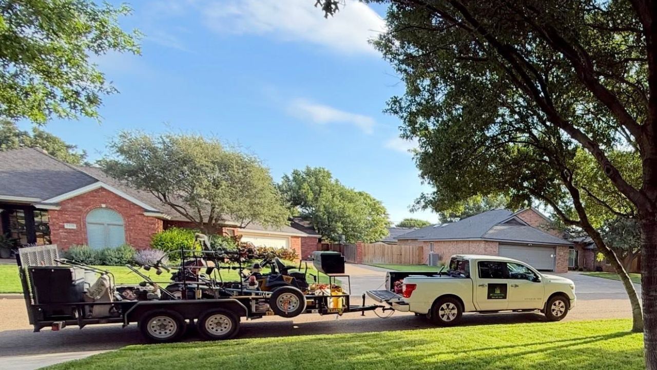 Lawn care owner sitting in work truck outside a Sudbury home