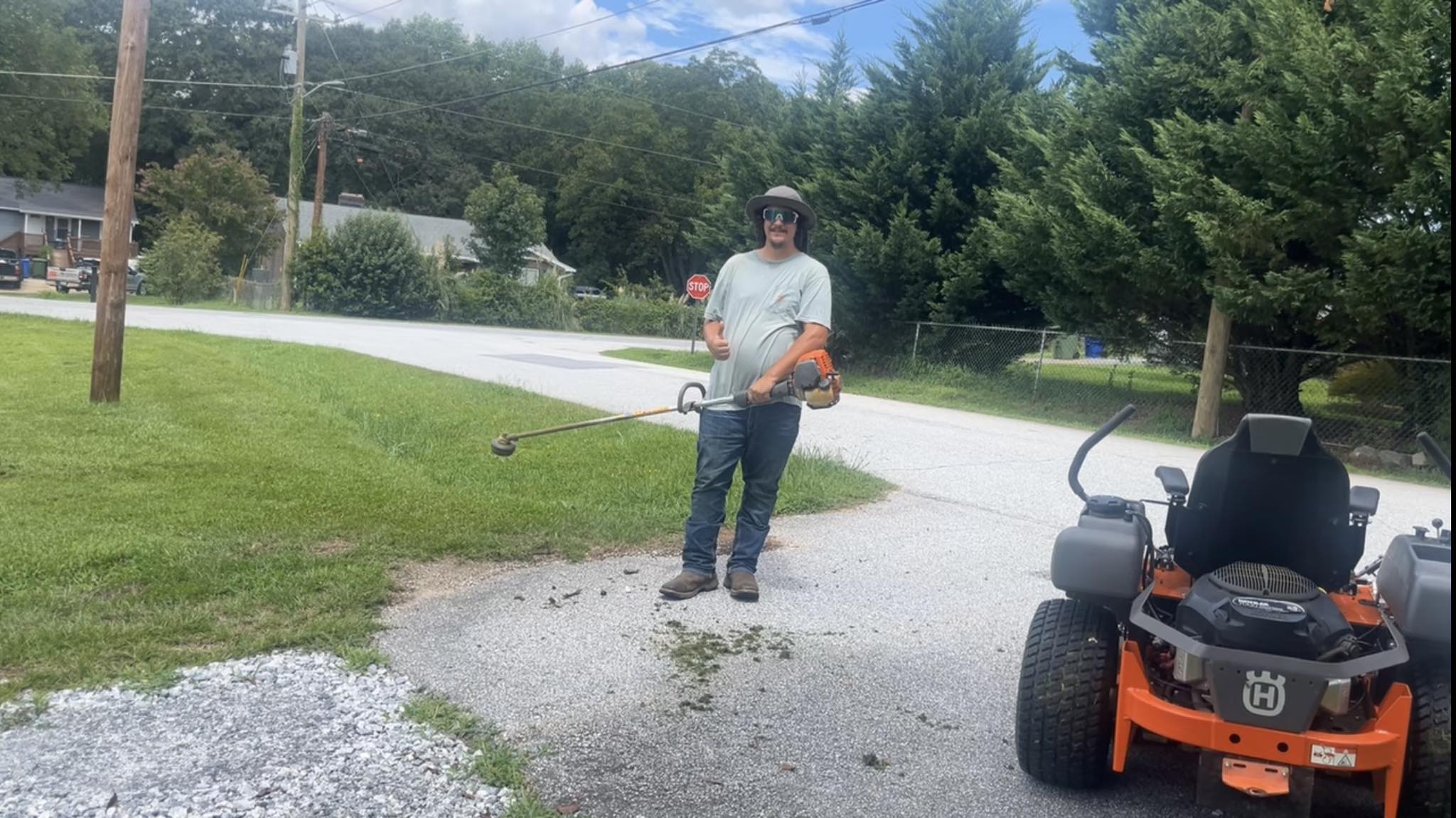 Lawn care professional walking and assessing a residential property in Greater Sudbury Ontario
