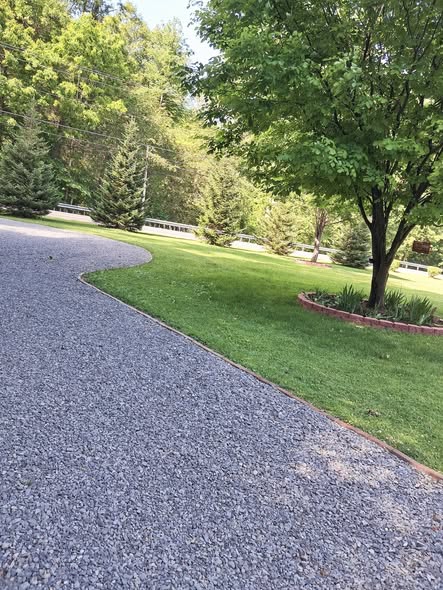 New gravel driveway being installed on a Sudbury residential property with proper base