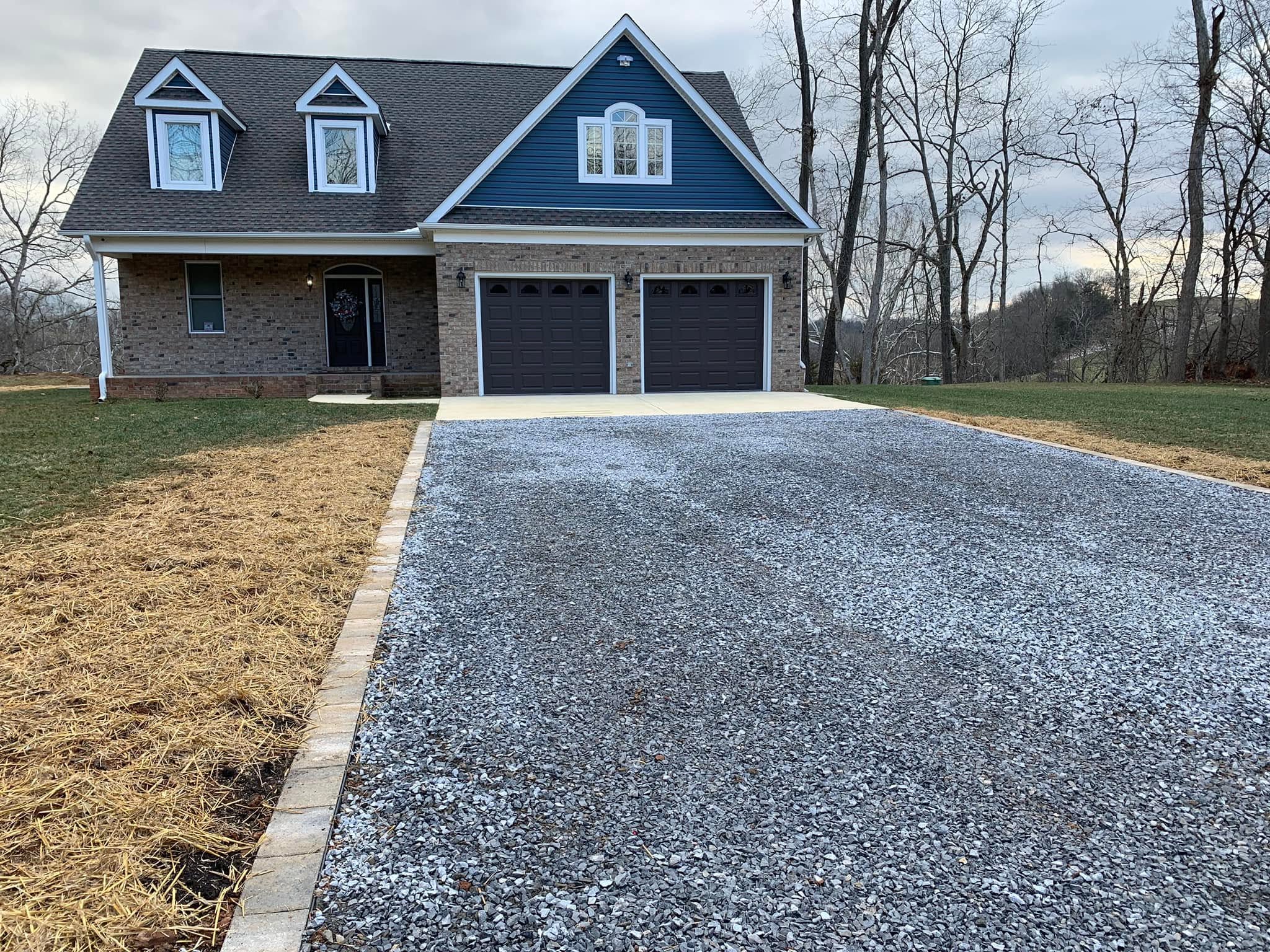 Properly graded crowned gravel driveway with good drainage on a Sudbury Ontario residential property