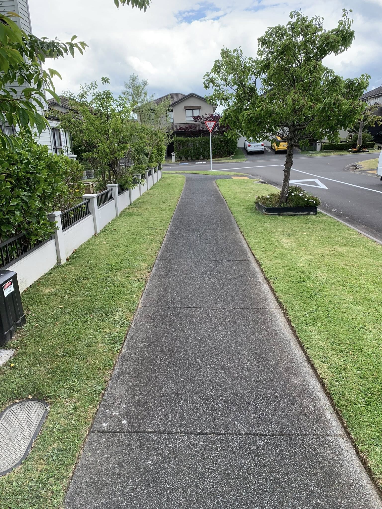 Residential street in Greater Sudbury Ontario showing varying lawn quality across neighbouring properties