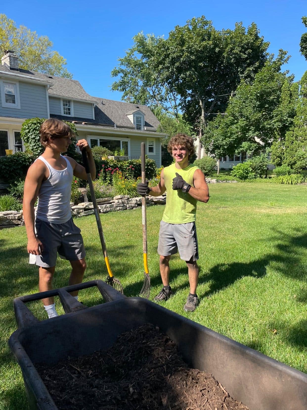 Ryan Lingenfelter and young worker having a serious conversation about lawn care quality in Sudbury Ontario