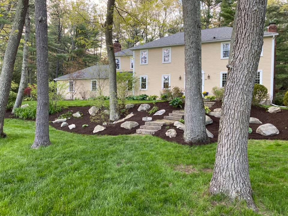 Ryan Lingenfelter installing mulch and stone on Sudbury residential property