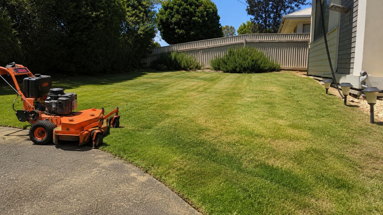 Ryan Lingenfelter mowing residential lawn in Greater Sudbury Ontario