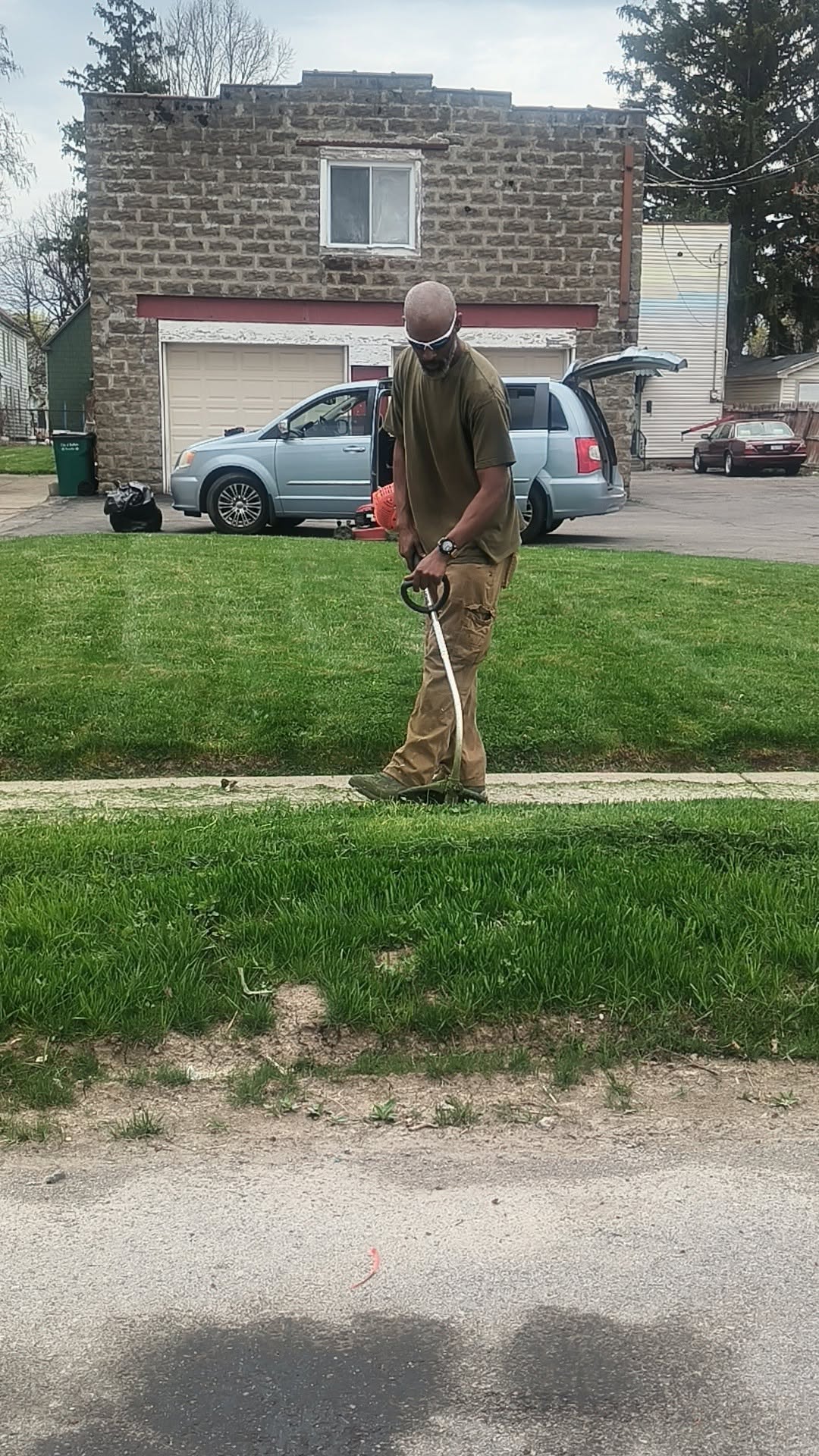 Ryan Lingenfelter professional lawn care crew working residential property Greater Sudbury Ontario