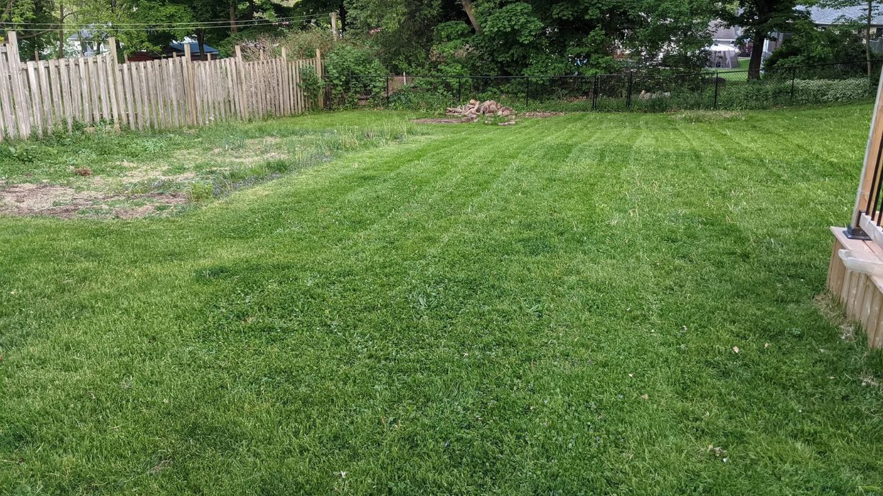 Ryan Lingenfelter teaching young person how to mow lawn correctly residential property Greater Sudbury Ontario