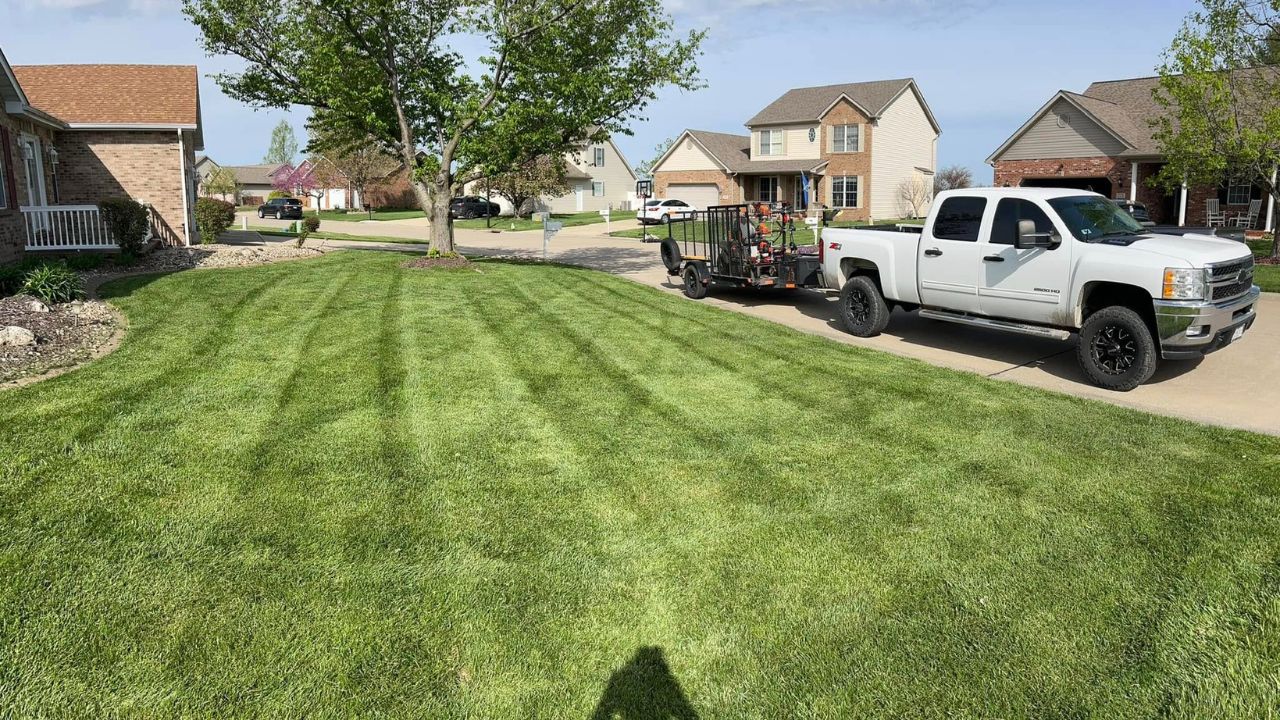 Ryan Lingenfelter working residential lawn during critical spring care window Greater Sudbury Ontario late May