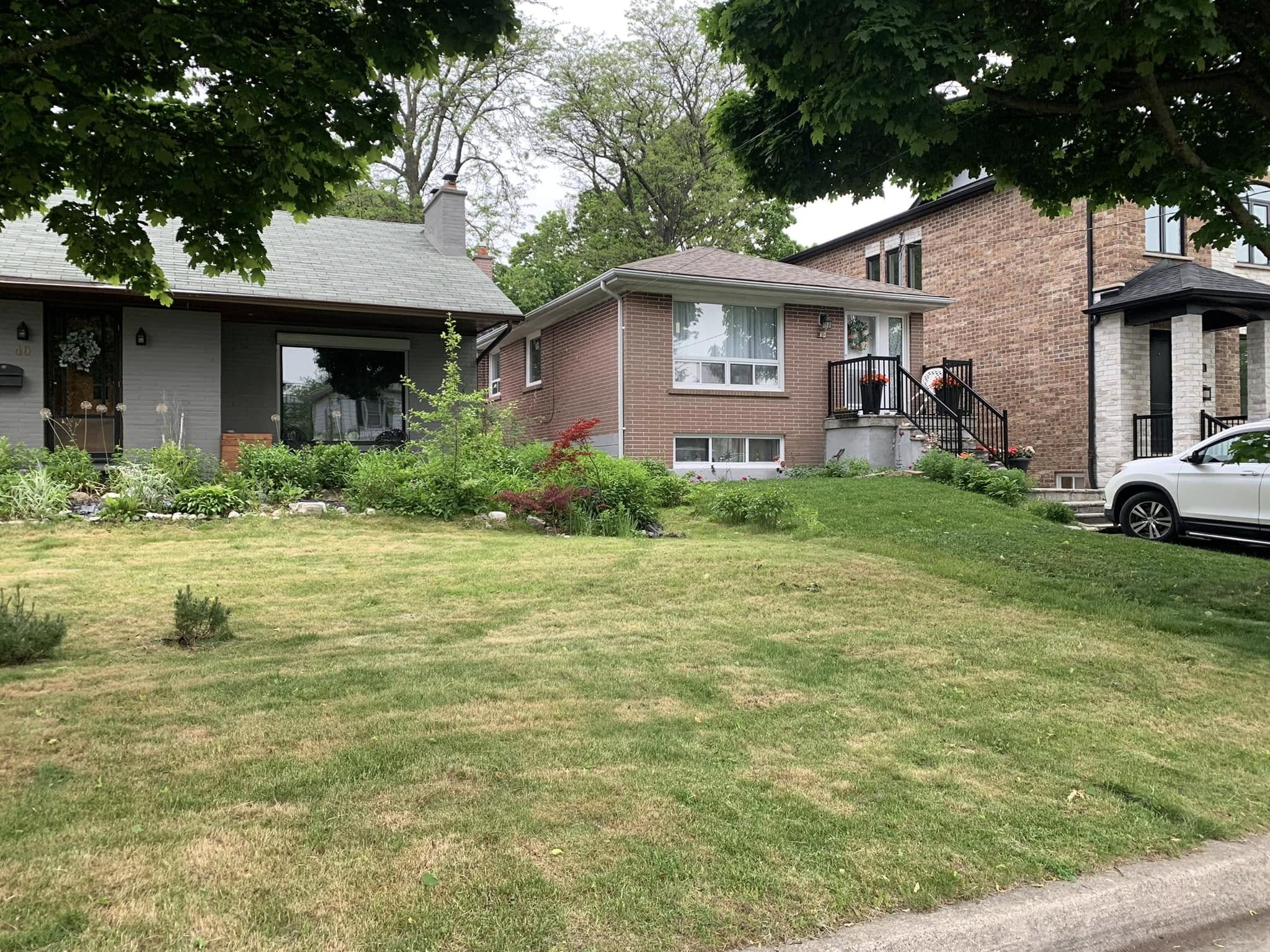 Side by side neighbouring houses Sudbury Ontario lawn comparison routine
