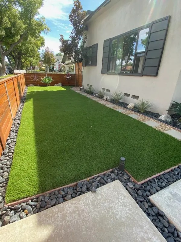 Small courtyard area with artificial turf in shaded Sudbury property