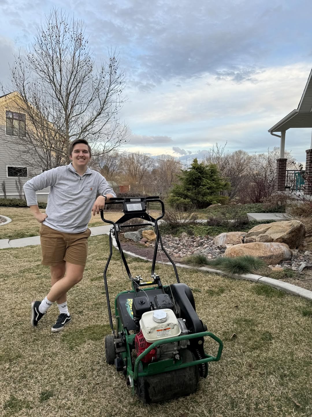 Spring lawn cleanup and aeration being done on a Sudbury property in May