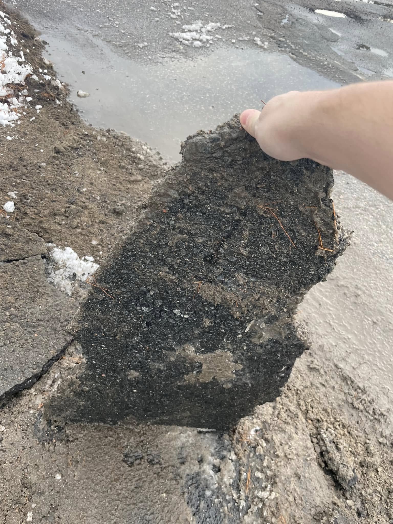 Sudbury gravel driveway showing seasonal damage from snowplow and spring runoff
