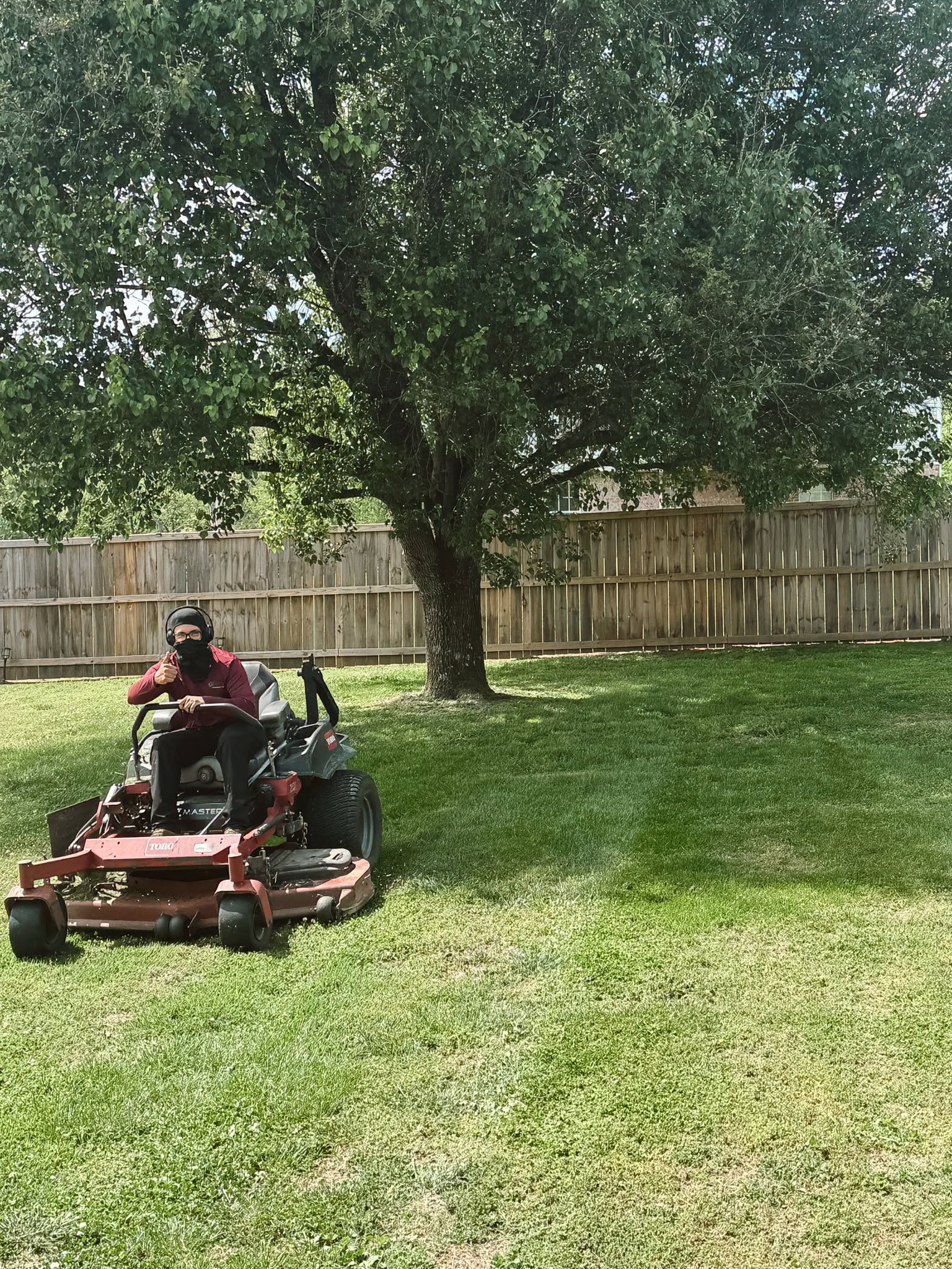 Sudbury homeowner listening to lawn care assessment at their front yard