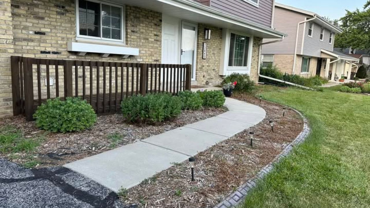 Sudbury homeowner standing in backyard asking Ryan Lingenfelter how long lawn transformation will take