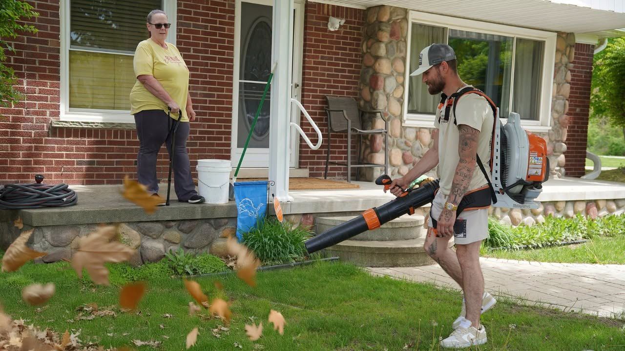 Sudbury homeowner standing on a porch looking at their lawn