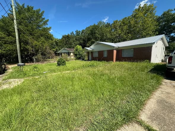 Overgrown rental property lawn in Greater Sudbury with visible neglect