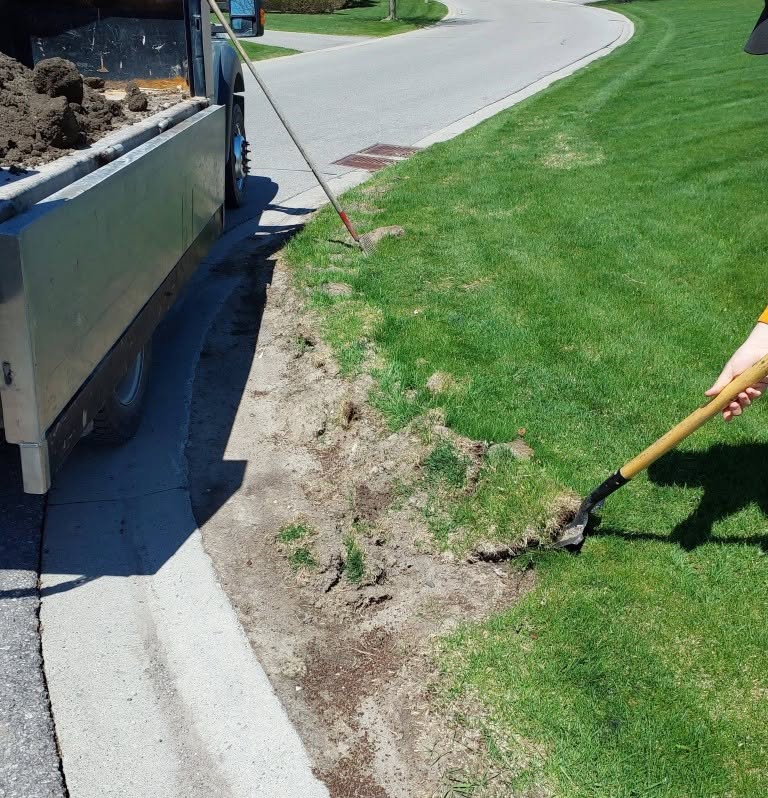 Ryan Lingenfelter assessing driveway edge condition on Sudbury property