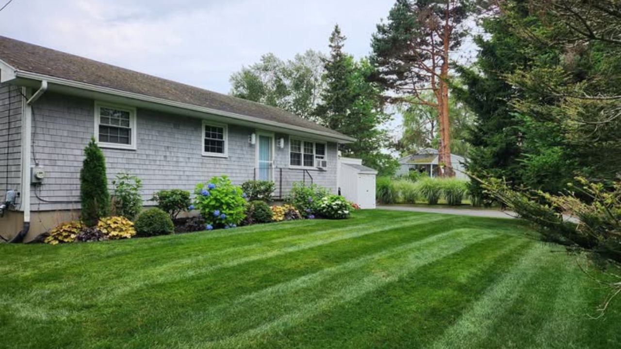 Ryan Lingenfelter talking with a Sudbury homeowner during a lawn assessment before starting work