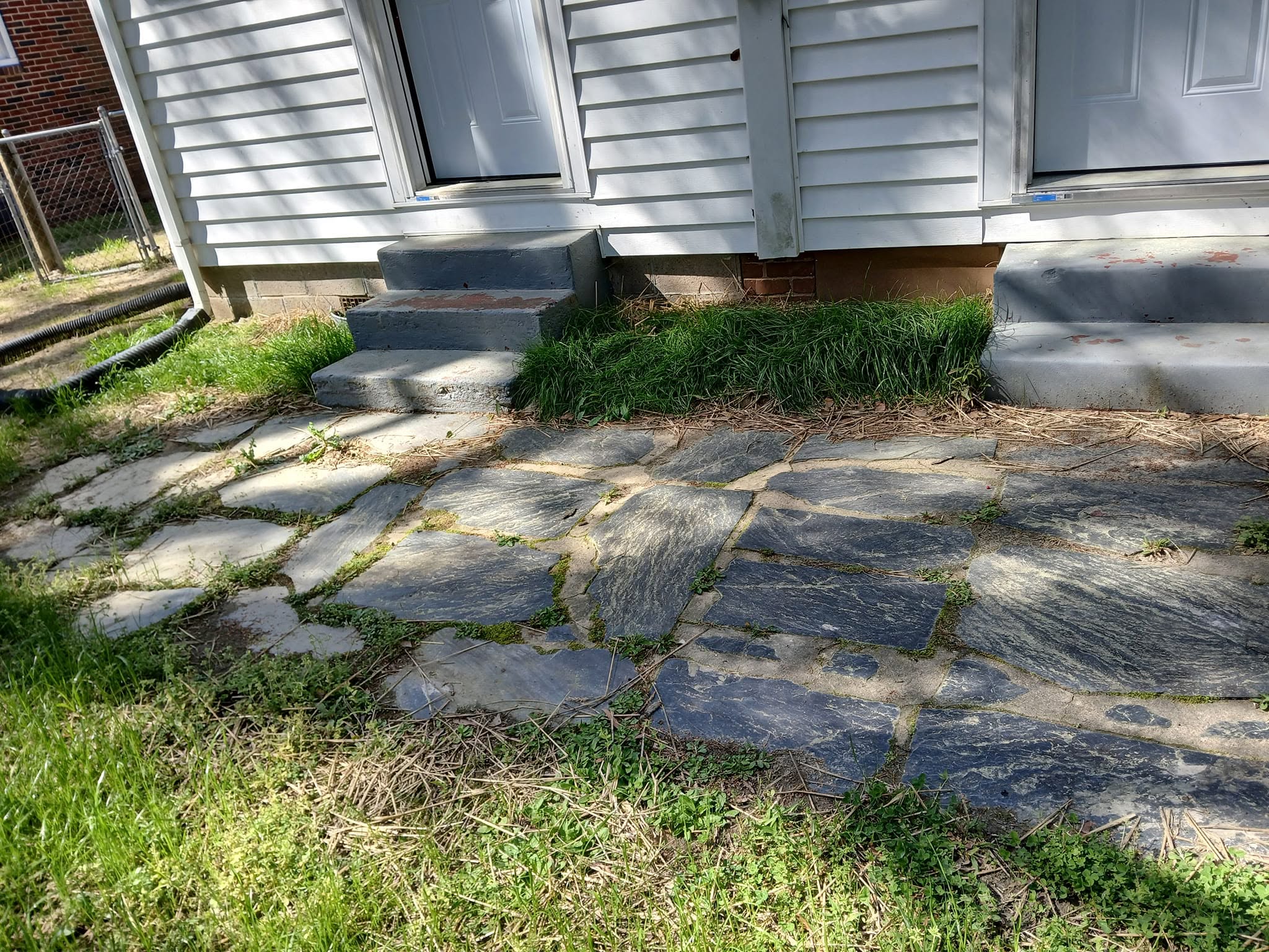 Sudbury homeowner and neighbour discussing downspout redirection to fix lawn drainage