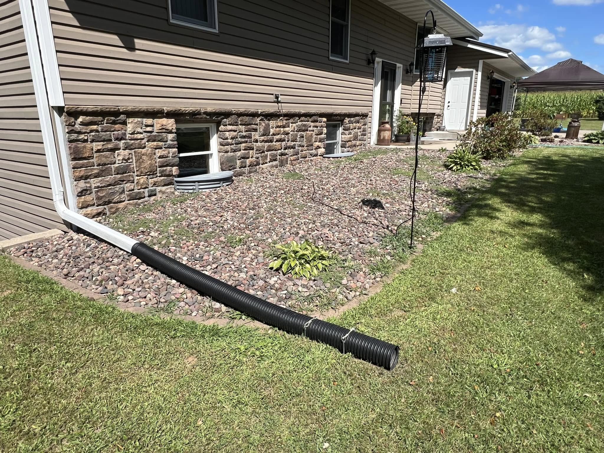 Three different downspout drainage scenarios affecting adjacent Sudbury lawns